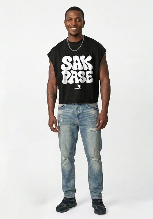 Man wearing a black t-shirt with 'Sak Pase' text and blue jeans on a white background