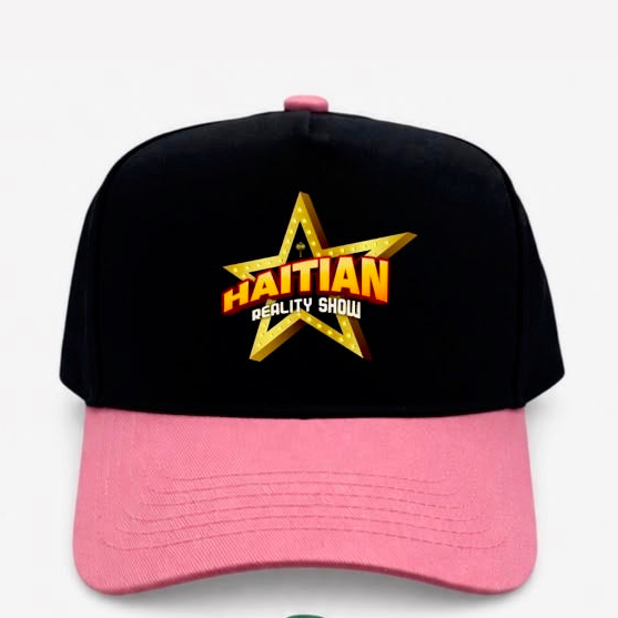A black and pink baseball cap featuring a large gold star logo on the front with the text 'HAITIAN REALITY SHOW' in orange and white.