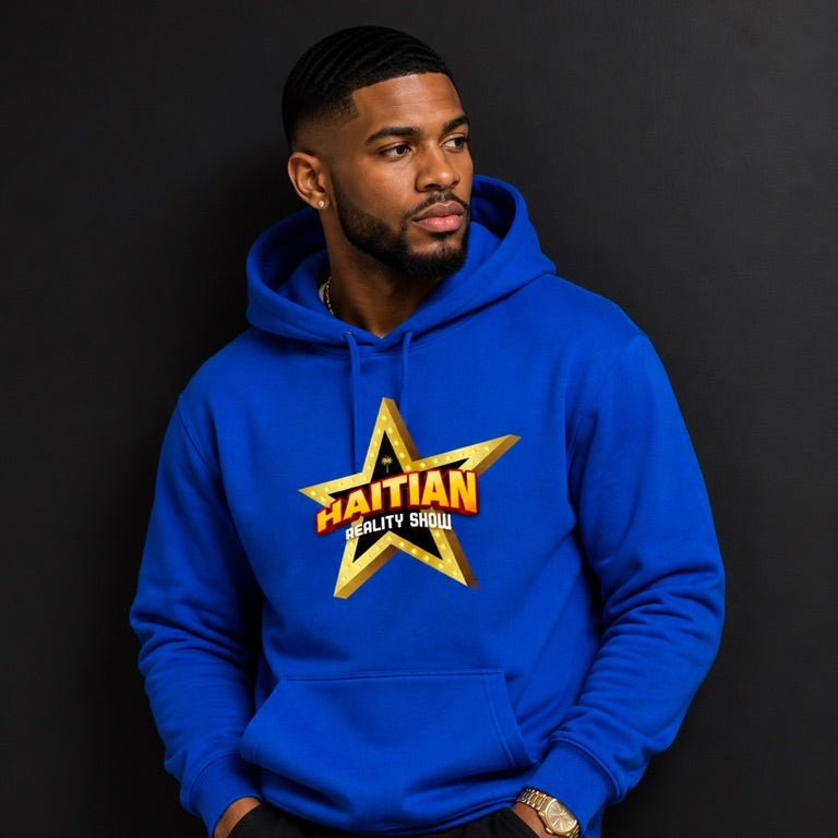 A man wearing a bright blue hoodie with a large gold and orange star graphic on the chest that reads 'HAITIAN GLUTY SHOW', posed against a dark studio background.